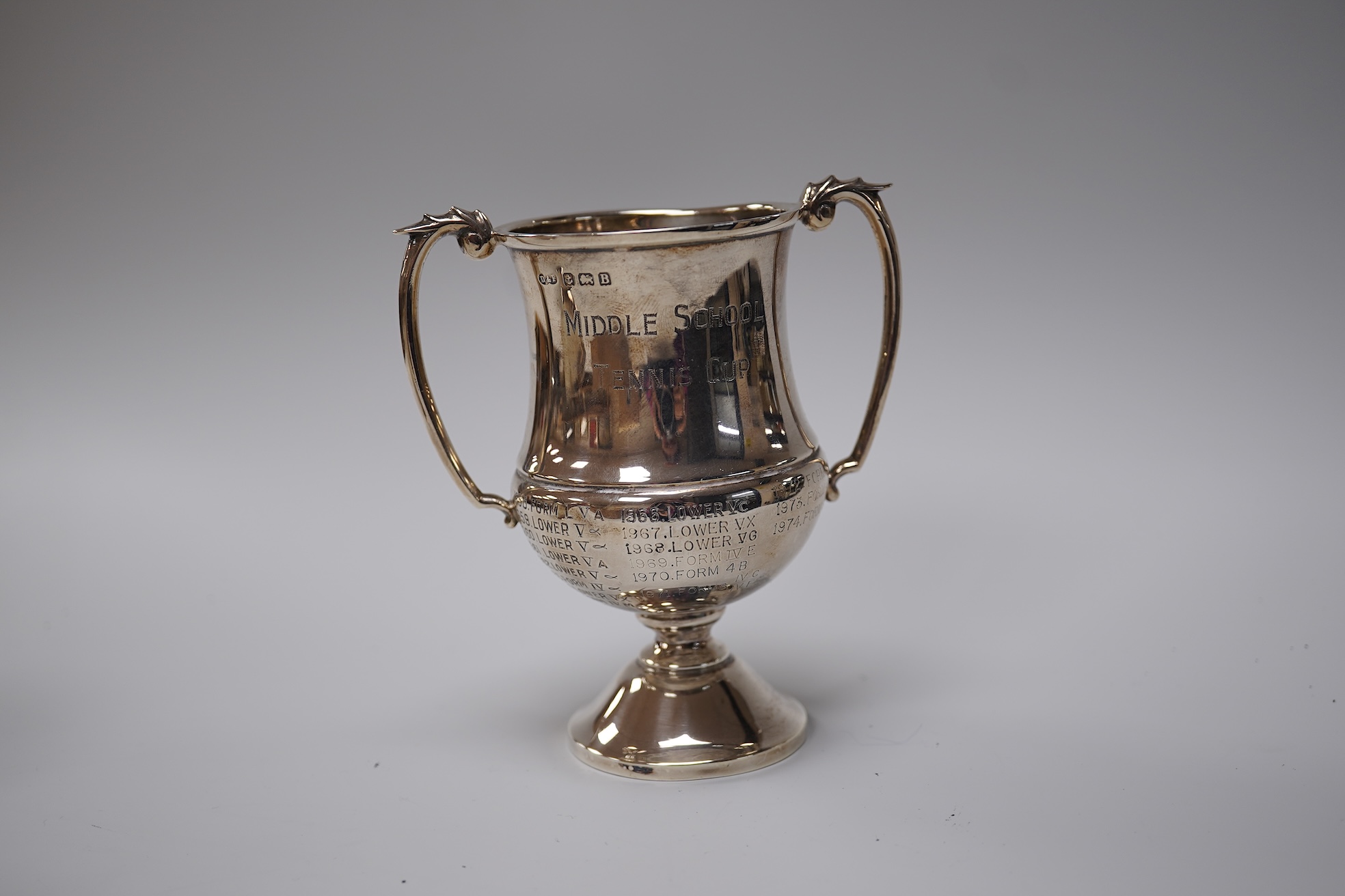 A George V silver christening mug, George Howson, Sheffield, 1934, height 77mm, together with one other silver mug, a small silver two handled cup, a silver salt and a small quantity of assorted silver flatware, 22.7oz.